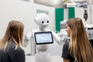 Students interact with Pepper a humanoid robot